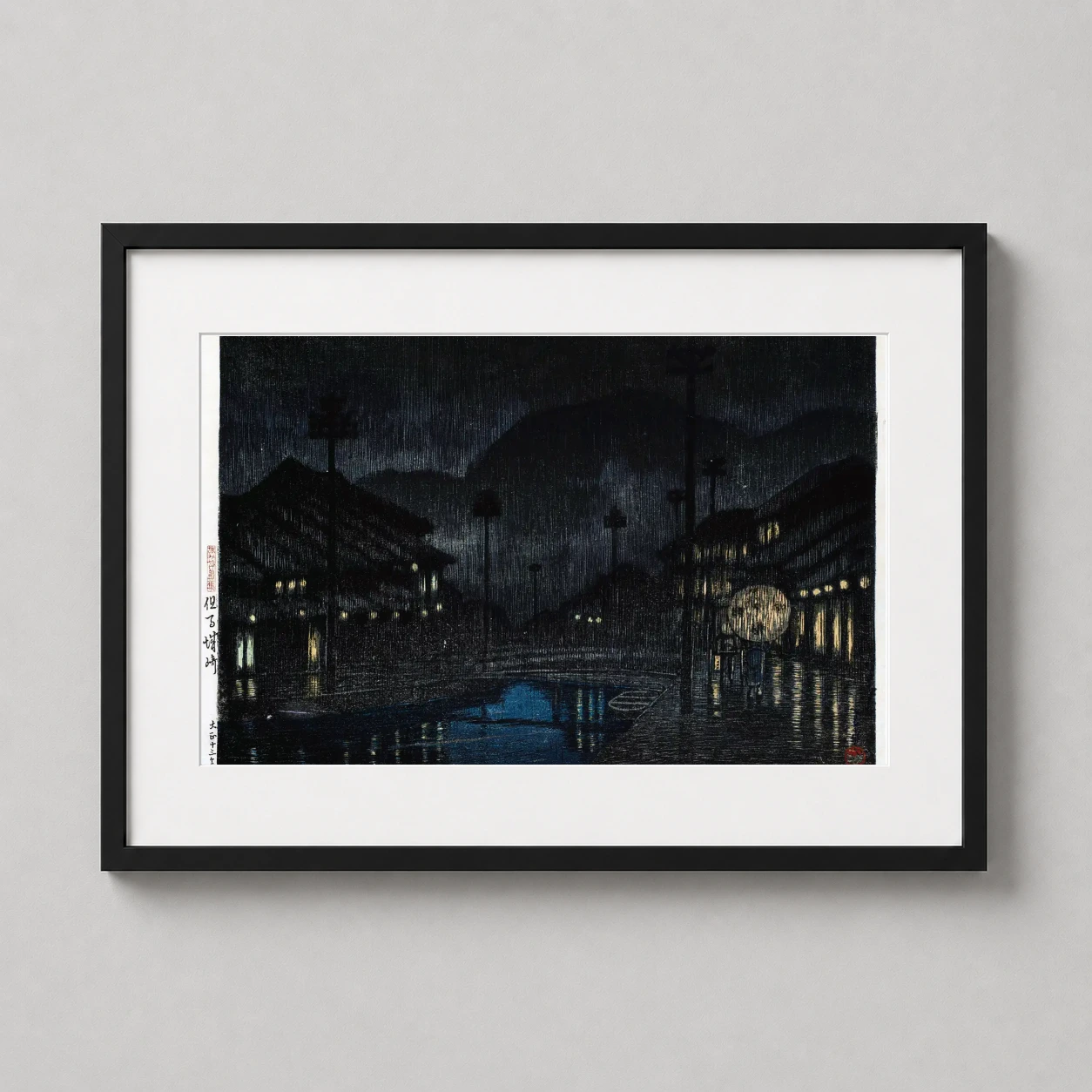 Room mockup of Kinosaki Tajima Japanese Woodblock Art Print by Kawase Hasui, displayed as framed wall art in a bedroom setting as a landscape print with blue and yellow tones.