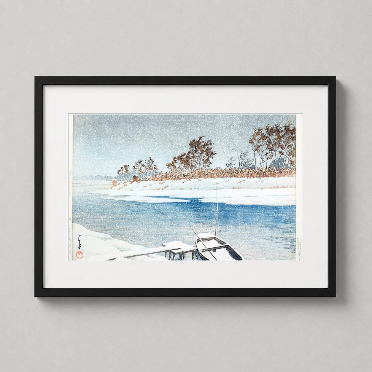 Room mockup of Kawase Hasui Snow at Koshigaya Japanese Woodblock Art Print, displayed as framed wall art in a bedroom setting as a landscape print with blue and white tones.