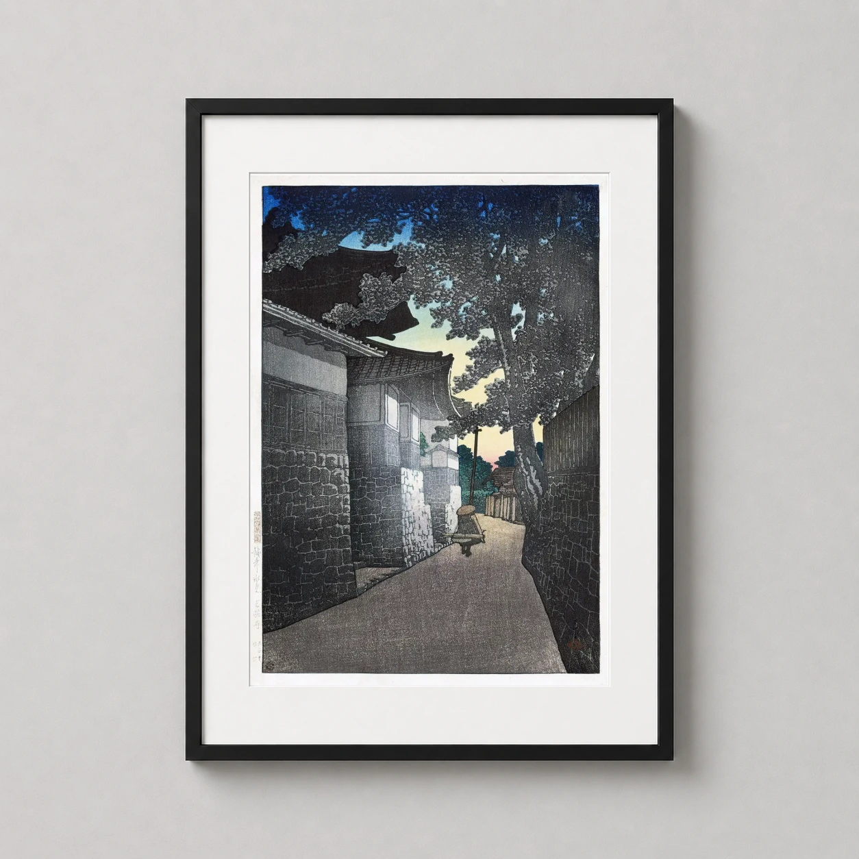 Room mockup of Kosho Temple by Kawase Hasui Japanese Woodblock Print Wall Art Print, displayed as framed wall art in a bedroom setting as a portrait print with blue tones.