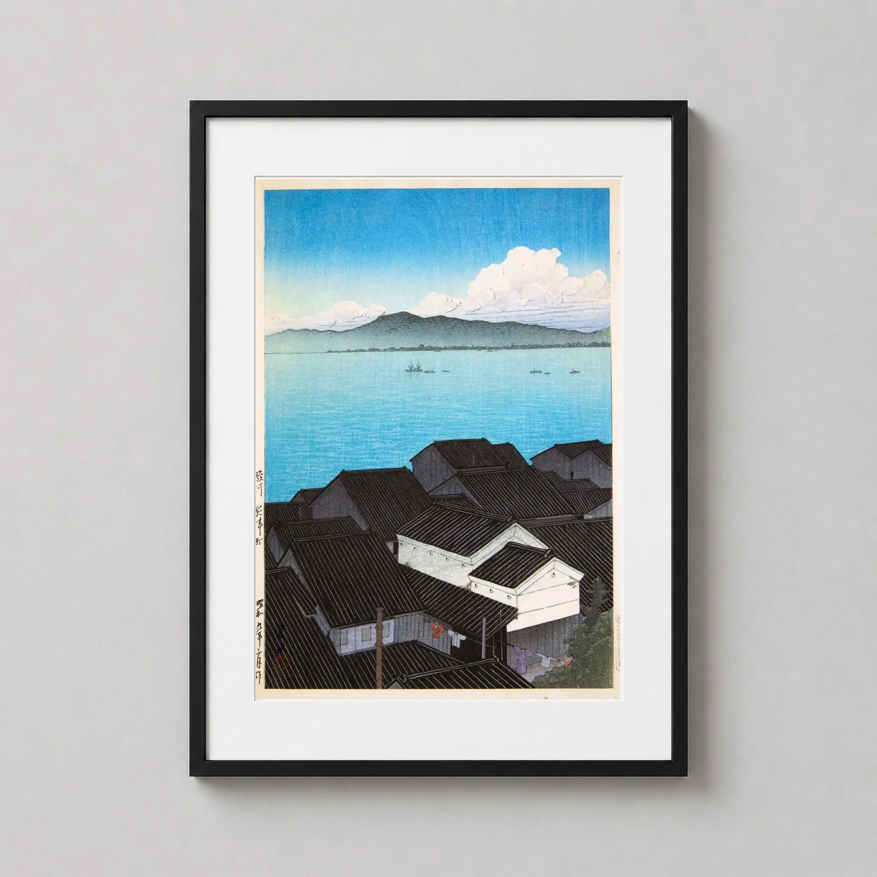 Room mockup of Kozu Town Suruga, Tsuchiya Koitsu Japanese Woodblock Art Print, displayed as framed wall art in a bedroom setting as a portrait print with blue tones.