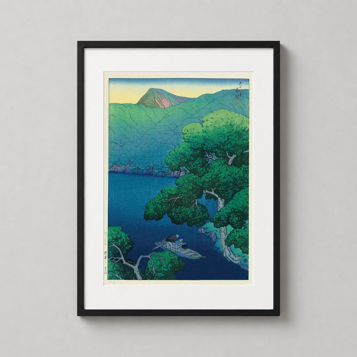 Room mockup of Mishima River Mutsu Province, Kawase Hasui Japanese Art Print, displayed as framed wall art in a bedroom setting as a portrait print with blue and green tones.