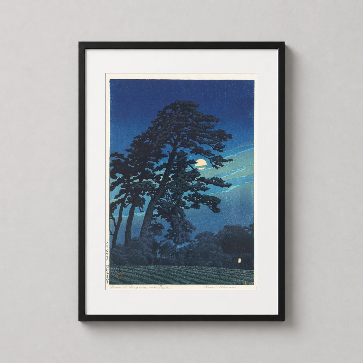 Room mockup of Moon at Magome near Omori Japanese Woodblock Art Print, displayed as framed wall art in a bedroom setting as a portrait print with blue tones.