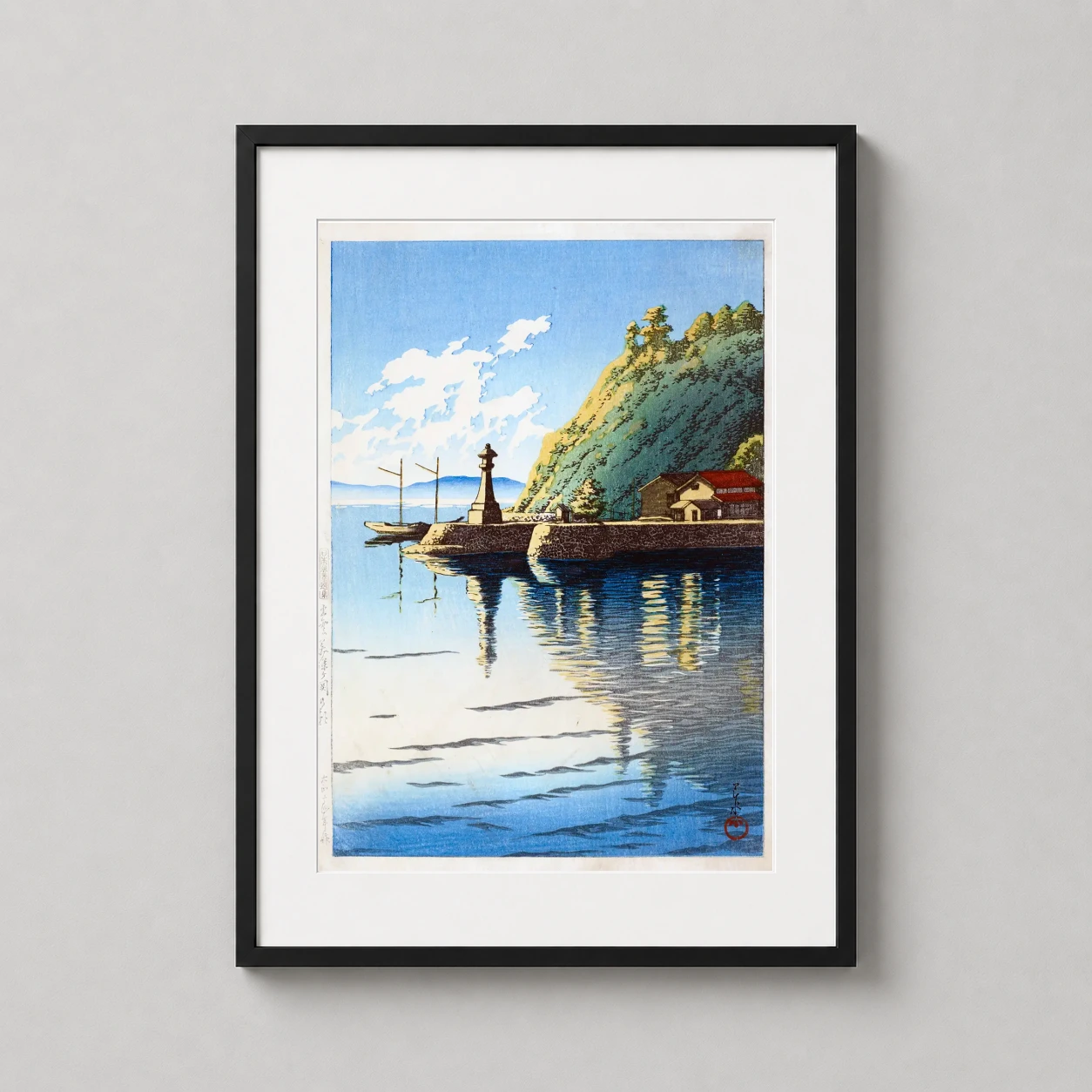 Room mockup of Mihogaseki Izumo Province Woodblock Art Print, Kawase Hasui, displayed as framed wall art in a bedroom setting as a portrait print with blue tones.