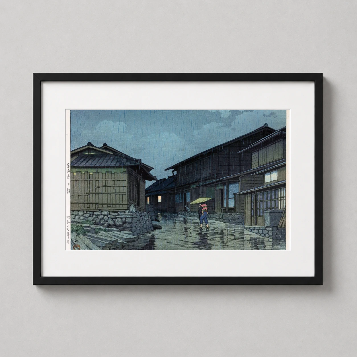 Room mockup of Hasui Kawase Rain in Nisaka 1942 Woodblock Japanese Art Print, displayed as framed wall art in a bedroom setting as a landscape print with blue and green tones.