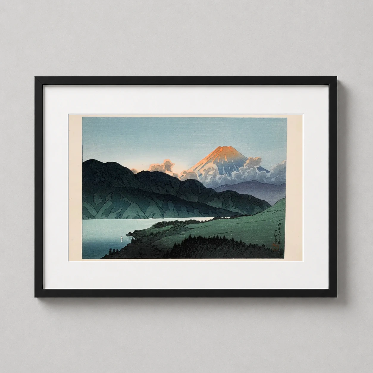 Room mockup of Mount Fuji at Evening from Lake Ashino Kawase Hasui Art Print, displayed as framed wall art in a bedroom setting as a landscape print with blue and yellow tones.