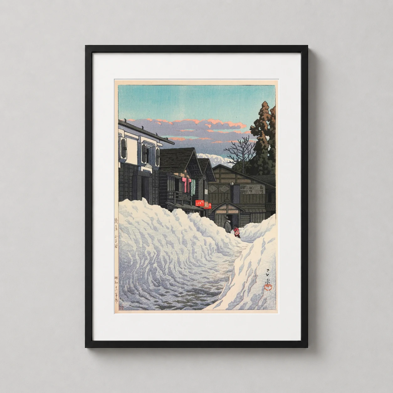 Room mockup of Ojiya Echigo Snowy Village by Hasui Kawase, Japanese Art Print, displayed as framed wall art in a bedroom setting as a portrait print with blue and pink tones.