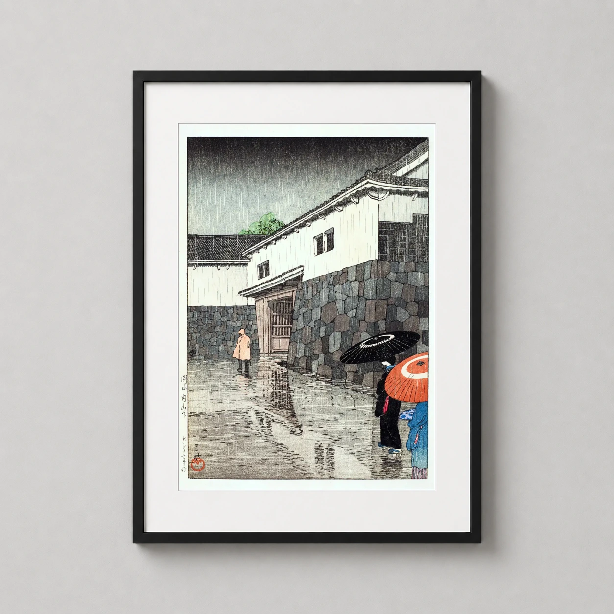 Room mockup of Kawase Hasui Okayama Under Uchiyama Japanese Woodblock Art Print, displayed as framed wall art in a bedroom setting as a portrait print with red and white tones.