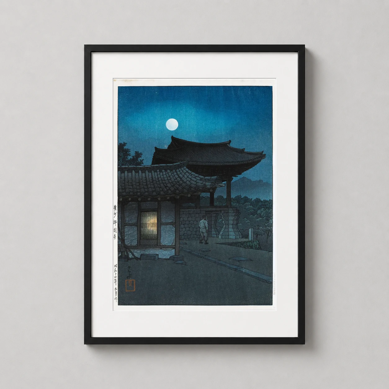 Room mockup of Bulguksa Temple Gyeongju Moonlit Night Woodblock Art Print, displayed as framed wall art in a bedroom setting as a portrait print with blue and gold tones.