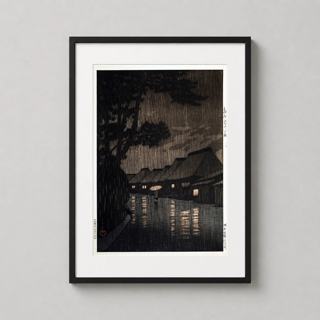 Room mockup of Rain at Maekawa Sagami Province by Kawase Hasui Art Print, displayed as framed wall art in a bedroom setting as a portrait print with blue and orange tones.