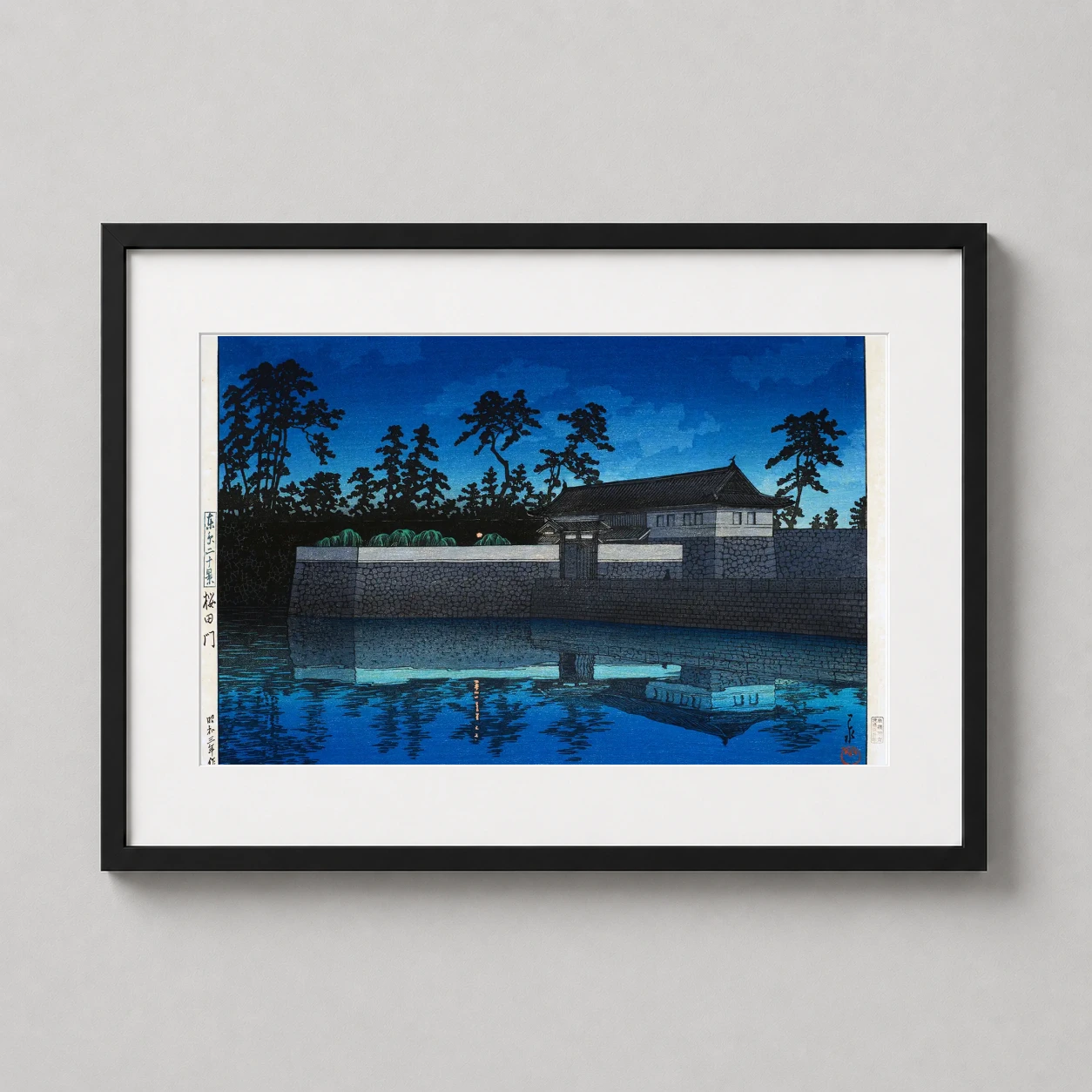 Room mockup of Sakurada Gate by Kawase Hasui, Japanese Woodblock Art Print, displayed as framed wall art in a bedroom setting as a landscape print with blue tones.