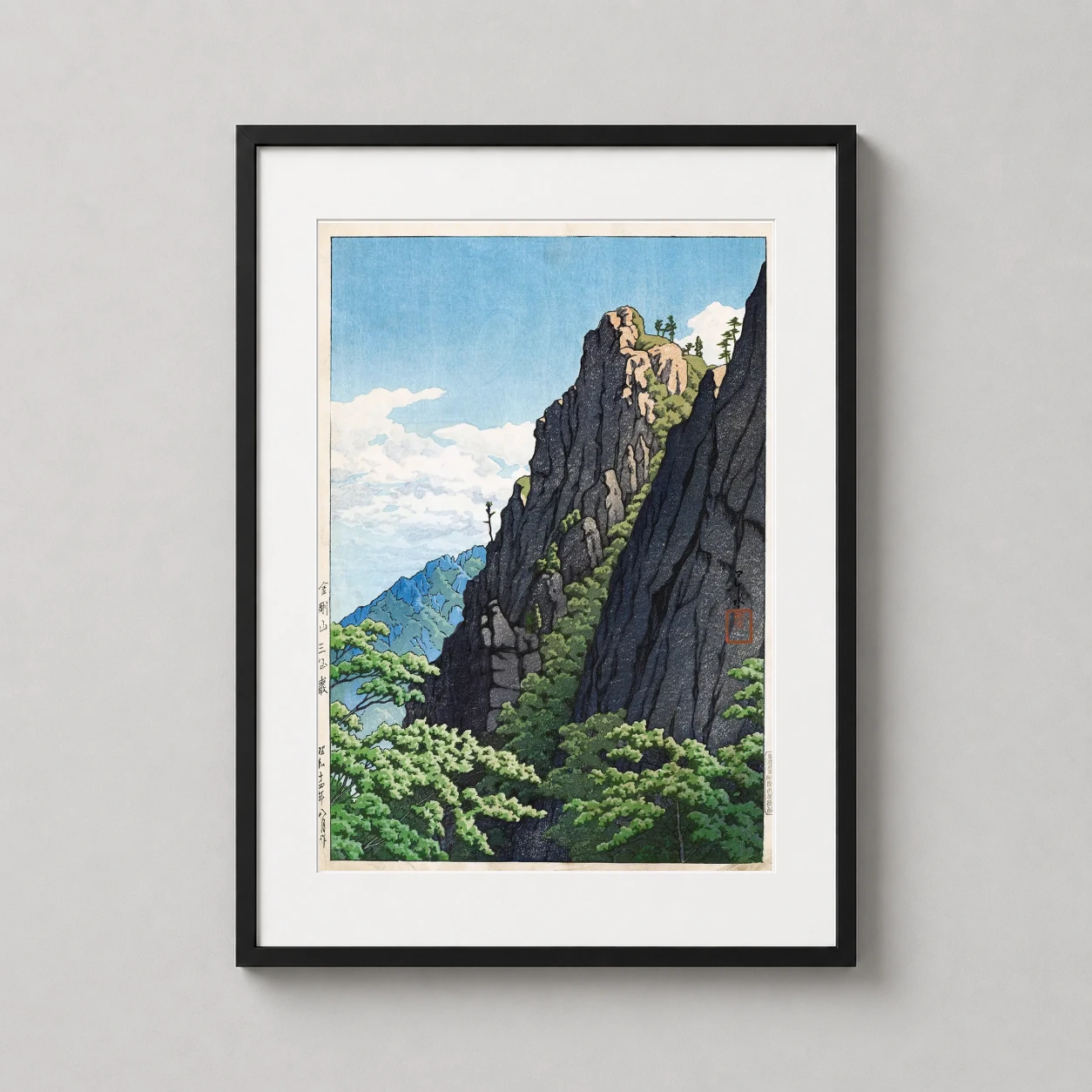 Room mockup of Kumgang Mountain Sansengan Rock, Kawase Hasui Art Print, displayed as framed wall art in a bedroom setting as a portrait print with blue tones.
