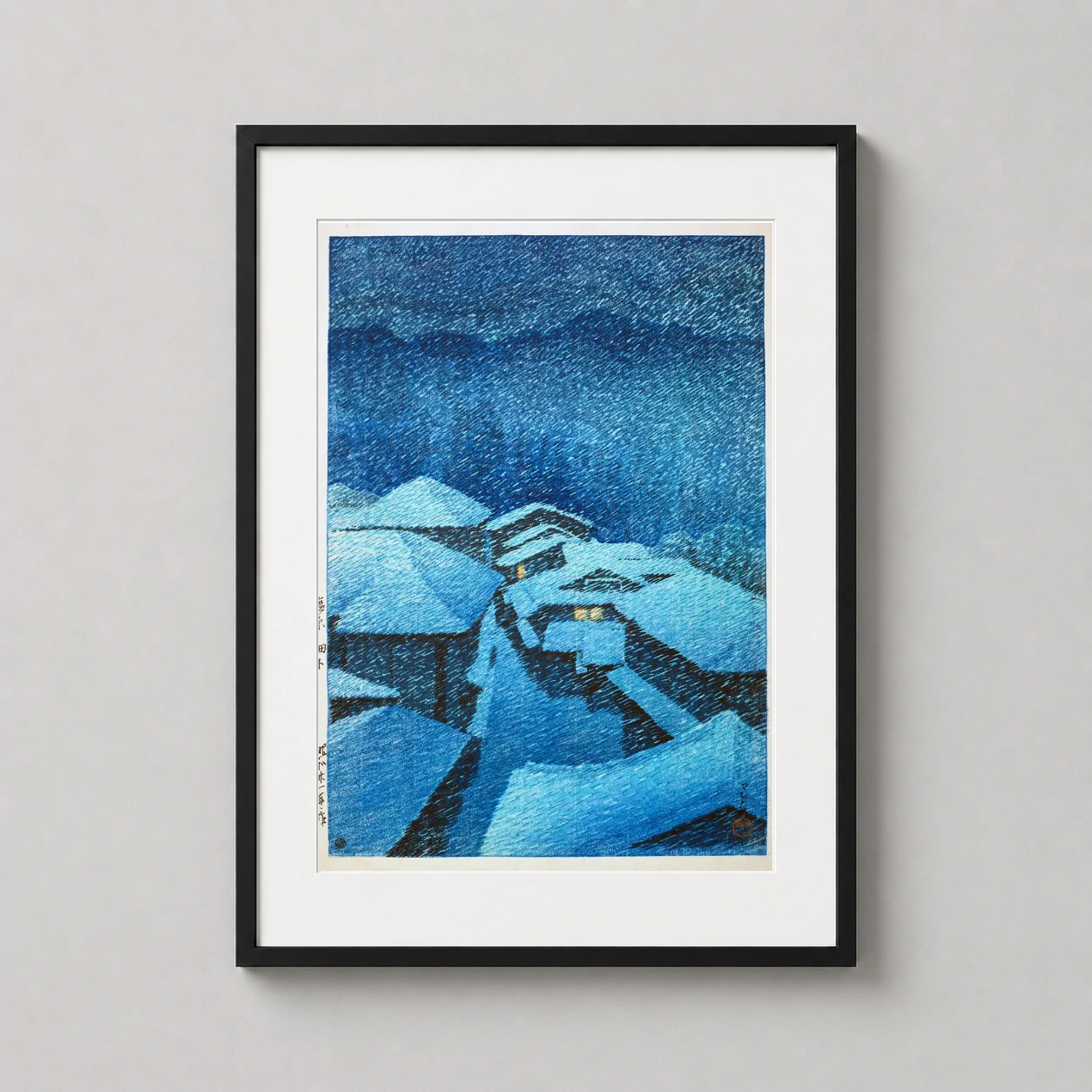 Room mockup of Shiobara Hataori Snowy Night, Kawase Hasui Japanese Art Print, displayed as framed wall art in a bedroom setting as a portrait print with blue and orange tones.