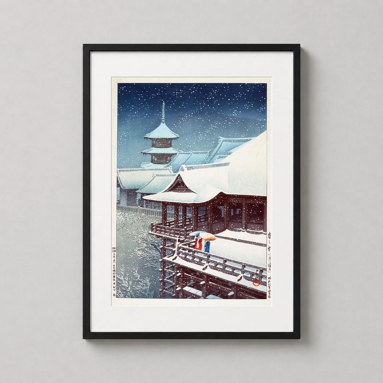 Room mockup of Spring Snow at Kiyomizu Temple, Kyoto, Kawase Hasui Art Print, displayed as framed wall art in a bedroom setting as a portrait print with blue tones.