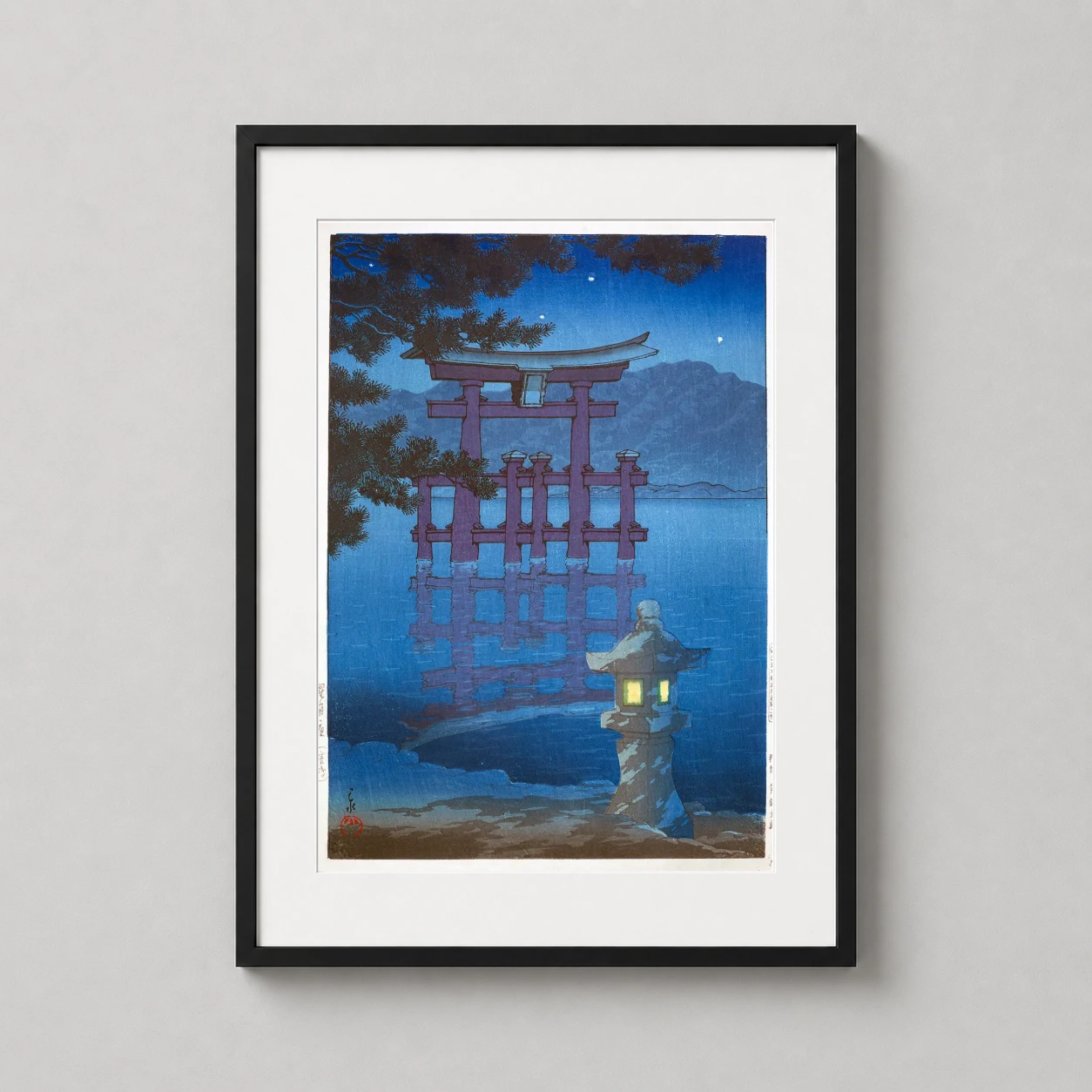 Room mockup of Miyajima Torii Gate Starlit Night Woodblock Japanese Art Print, displayed as framed wall art in a bedroom setting as a portrait print with blue and orange tones.