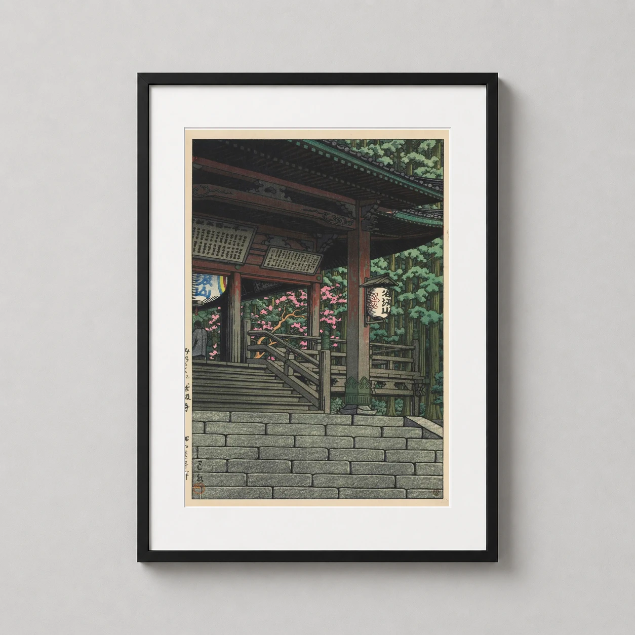 Room mockup of Tanigumi Temple, Mino Province, Kawase Hasui Woodblock Art Print, displayed as framed wall art in a bedroom setting as a portrait print with green and pink tones.