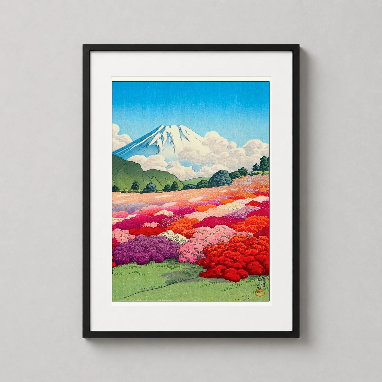 Room mockup of Mount Fuji and Azalea Garden, Japanese Woodblock Art Print, displayed as framed wall art in a bedroom setting as a portrait print with blue, red, and pink tones.