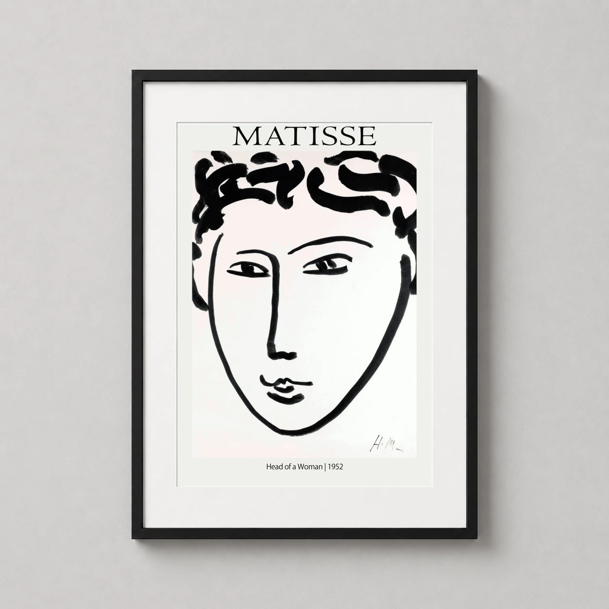Room mockup of Matisse Head of a Woman 1952 Minimalist Portrait Art Print, displayed as framed wall art in a living room setting as a portrait print with black and white tones.
