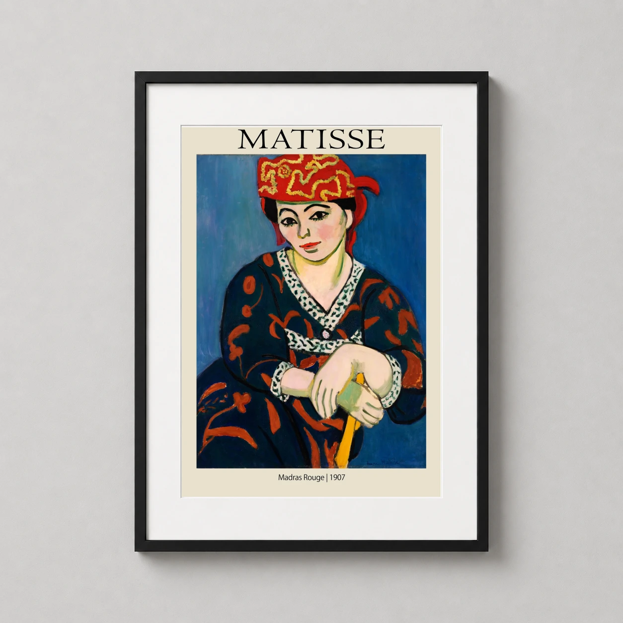 Room mockup of Madras Rouge 1907 by Henri Matisse, Exhibition Art Print, displayed as framed wall art in a living room setting as a portrait print with blue and red tones.