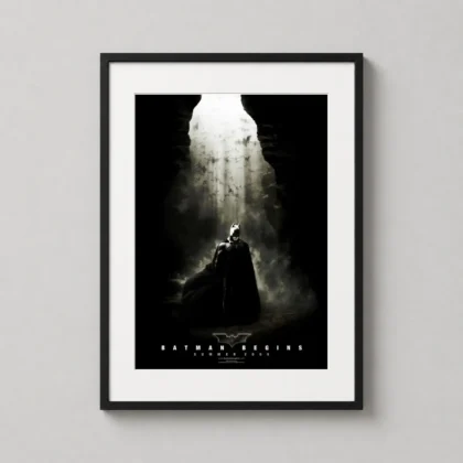 Batman Begins Movie Poster Wall Art in a black frame for a modern home theater setup. by MerchFuse