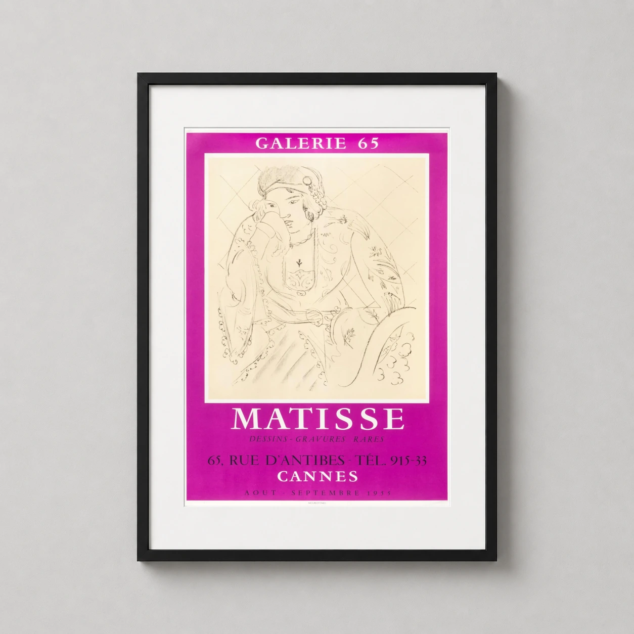 Room mockup of Matisse Galerie 65 Cannes 1955 Exhibition Poster Art Print, displayed as framed wall art in a living room setting as a portrait print with pink tones.