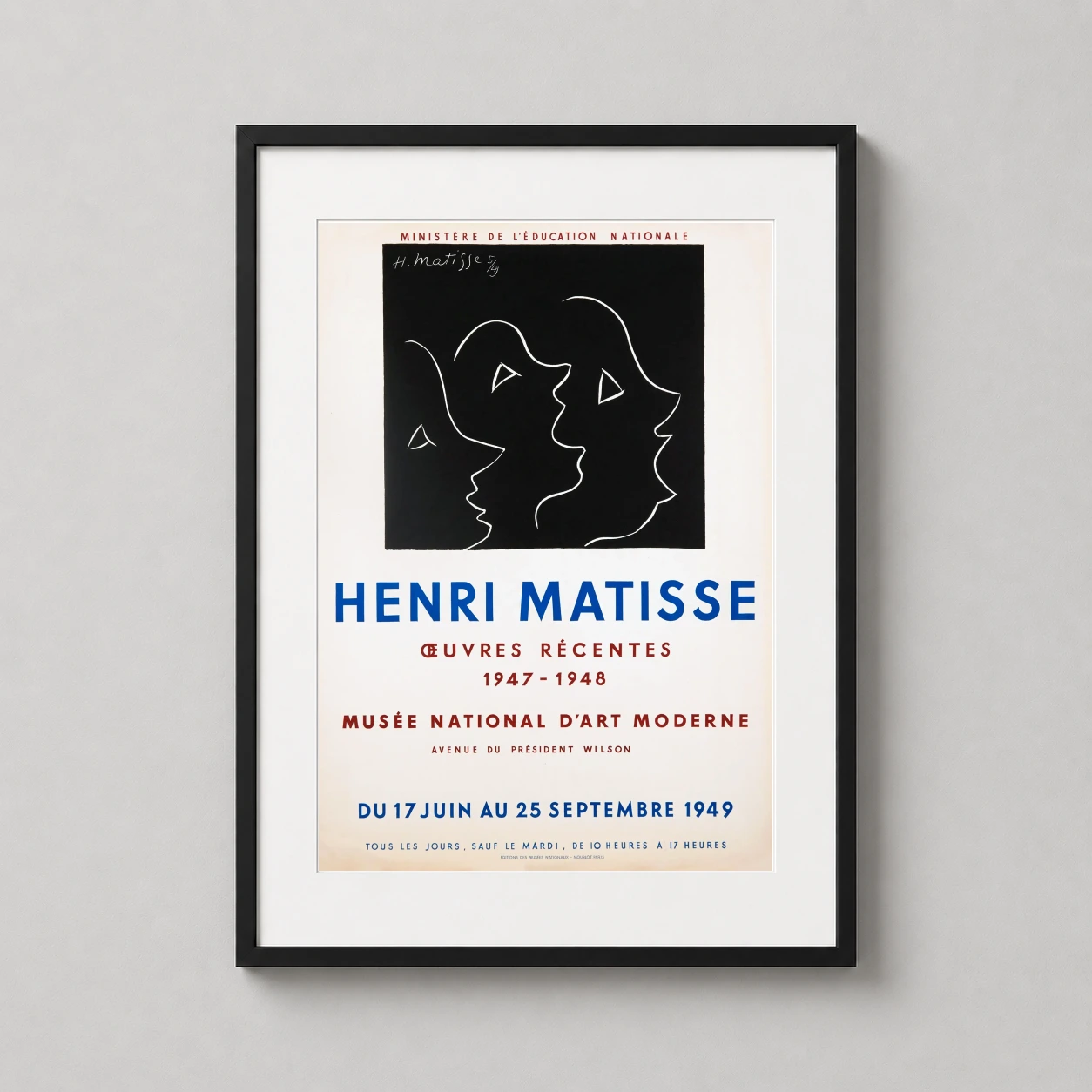 Room mockup of Matisse Musée National d'Art Moderne 1949 Exhibition Art Print, displayed as framed wall art in a living room setting as a portrait print with blue, red, and black tones.