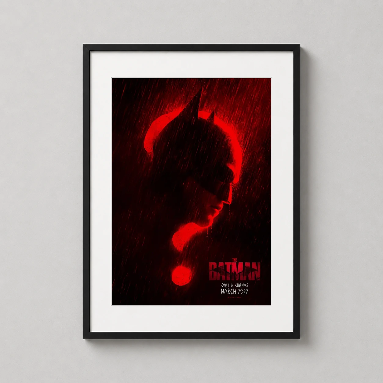 Room mockup of The Batman 2022 Robert Pattinson Red Silhouette Movie Poster, displayed as framed wall art in a home theater setting as a portrait print with red tones.