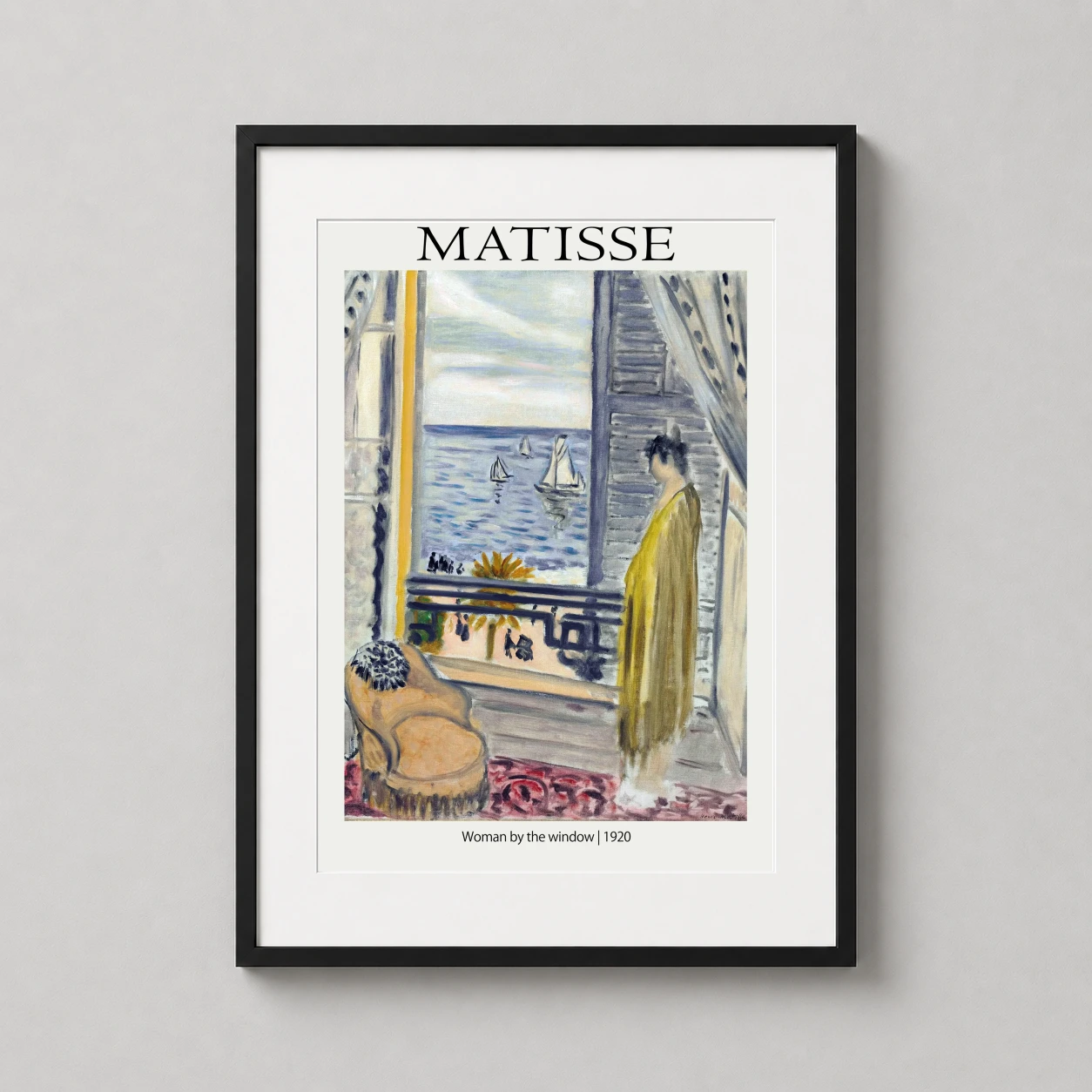 Room mockup of Henri Matisse Woman by the Window 1920 Impressionist Art Print, displayed as framed wall art in a living room setting as a portrait print with blue, yellow, and white tones.