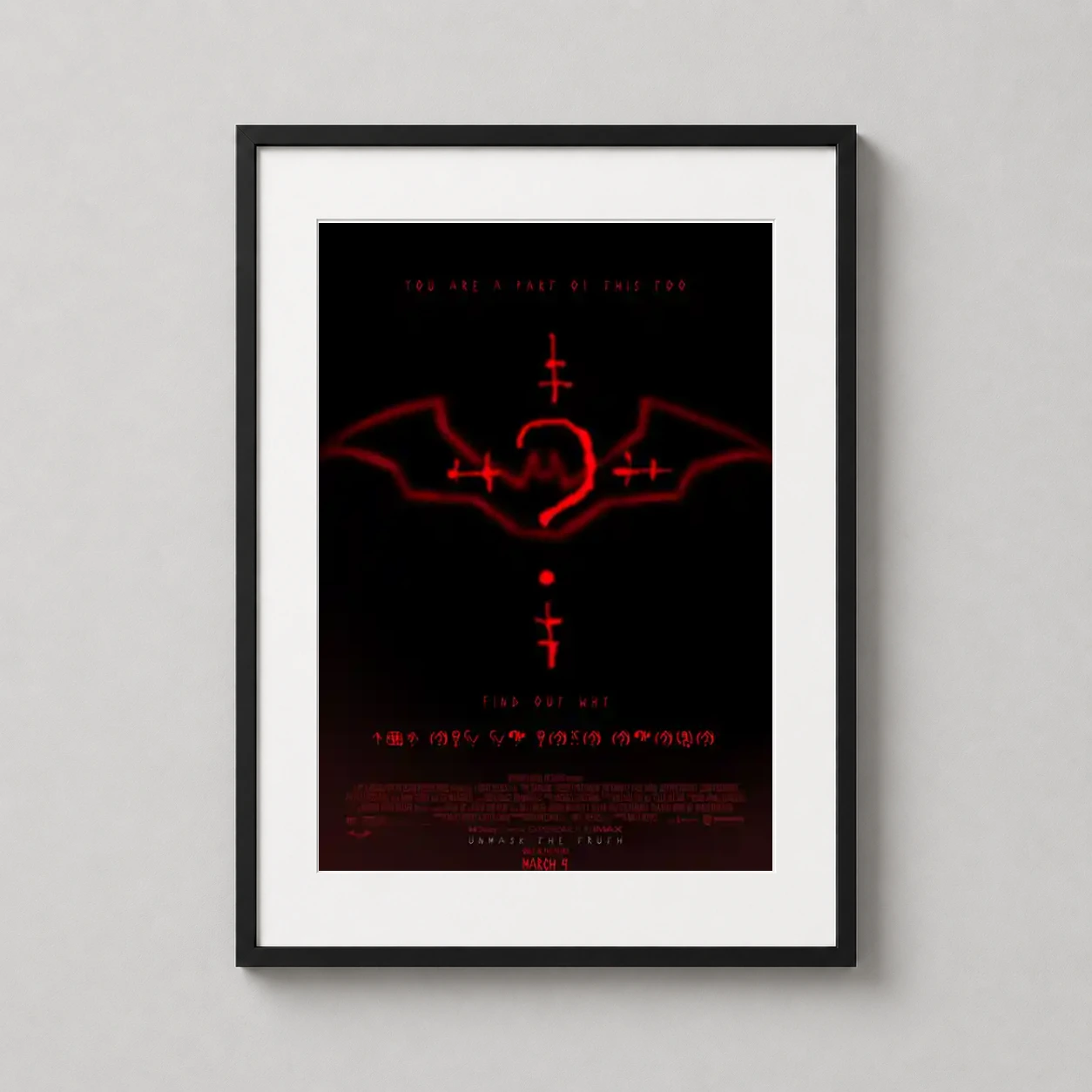 Room mockup of The Batman 2022 Red Neon Riddler Symbol Movie Poster, displayed as framed wall art in a home theater setting as a portrait print with red and black tones.
