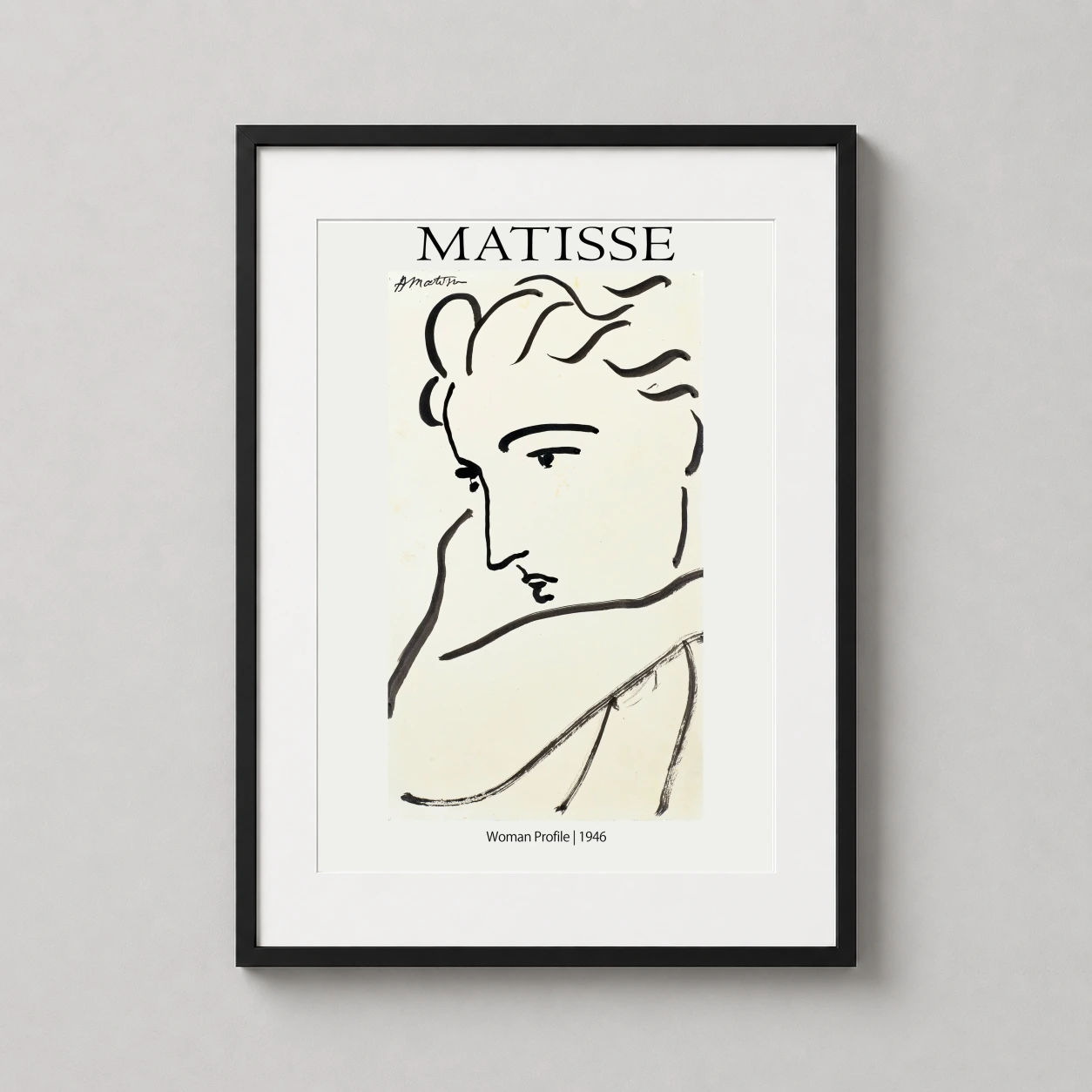 Room mockup of Henri Matisse Woman Profile 1946 Minimalist Sketch Art Print, displayed as framed wall art in a living room setting as a portrait print with black and white tones.