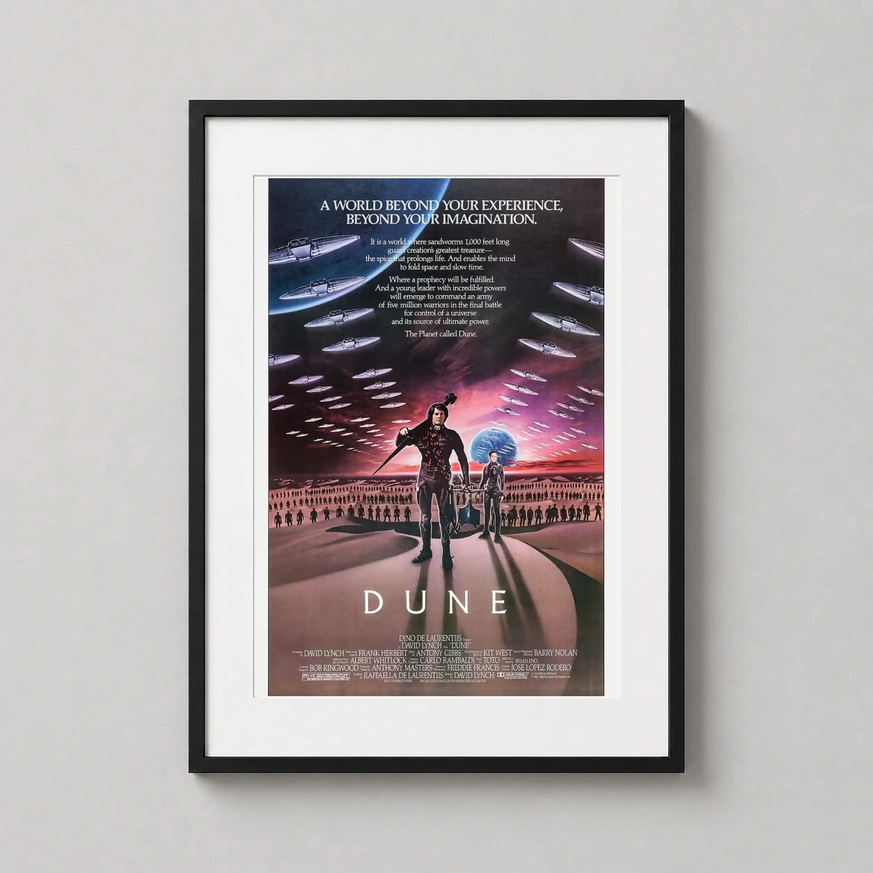 Room mockup of Dune 1984 David Lynch Science Fiction Movie Poster, displayed as framed wall art in a home theater setting as a portrait print with blue and gold tones.