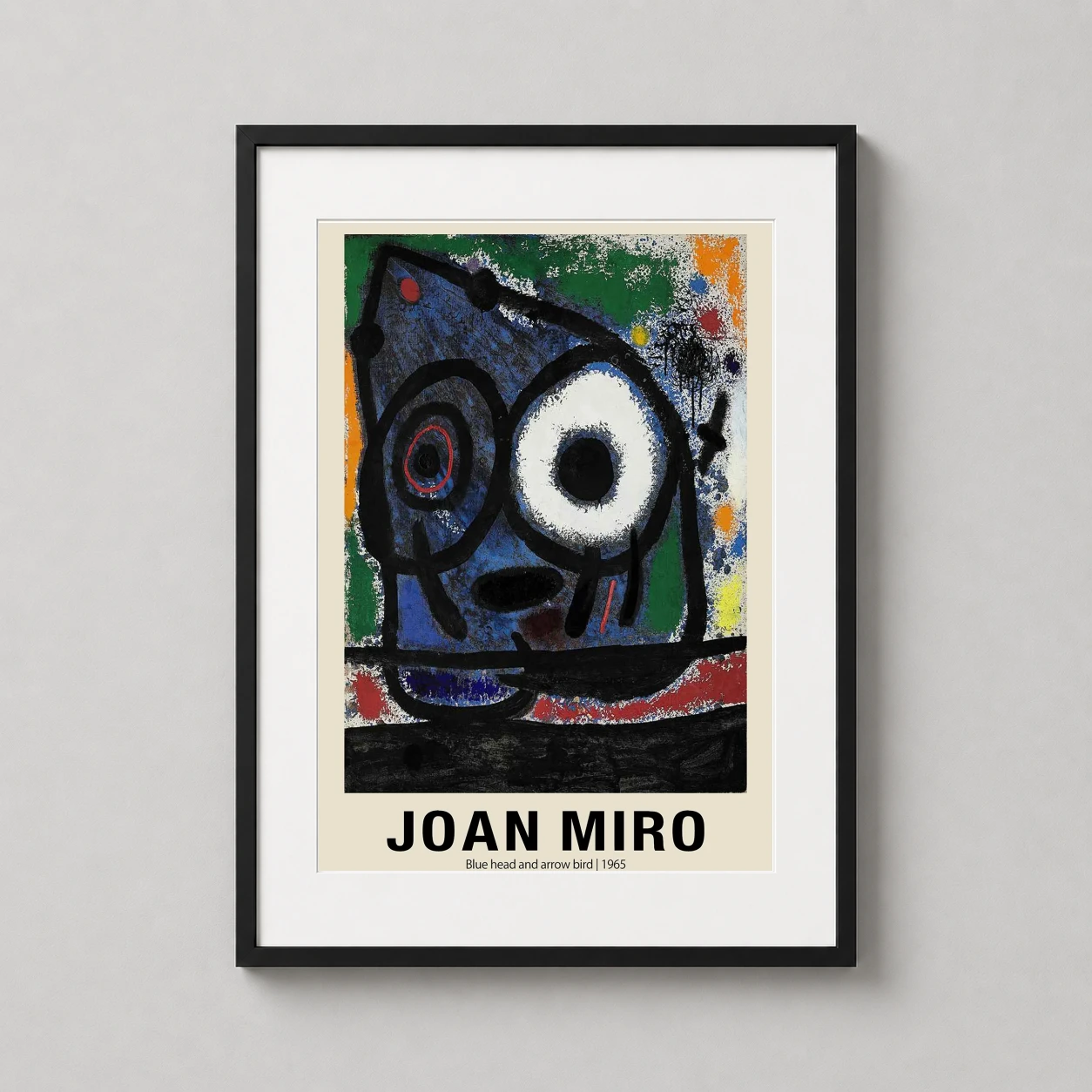 Room mockup of Joan Miró Blue Head and Arrow Bird 1965 Abstract Art Print, displayed as framed wall art in a bedroom setting as a portrait print with blue tones.