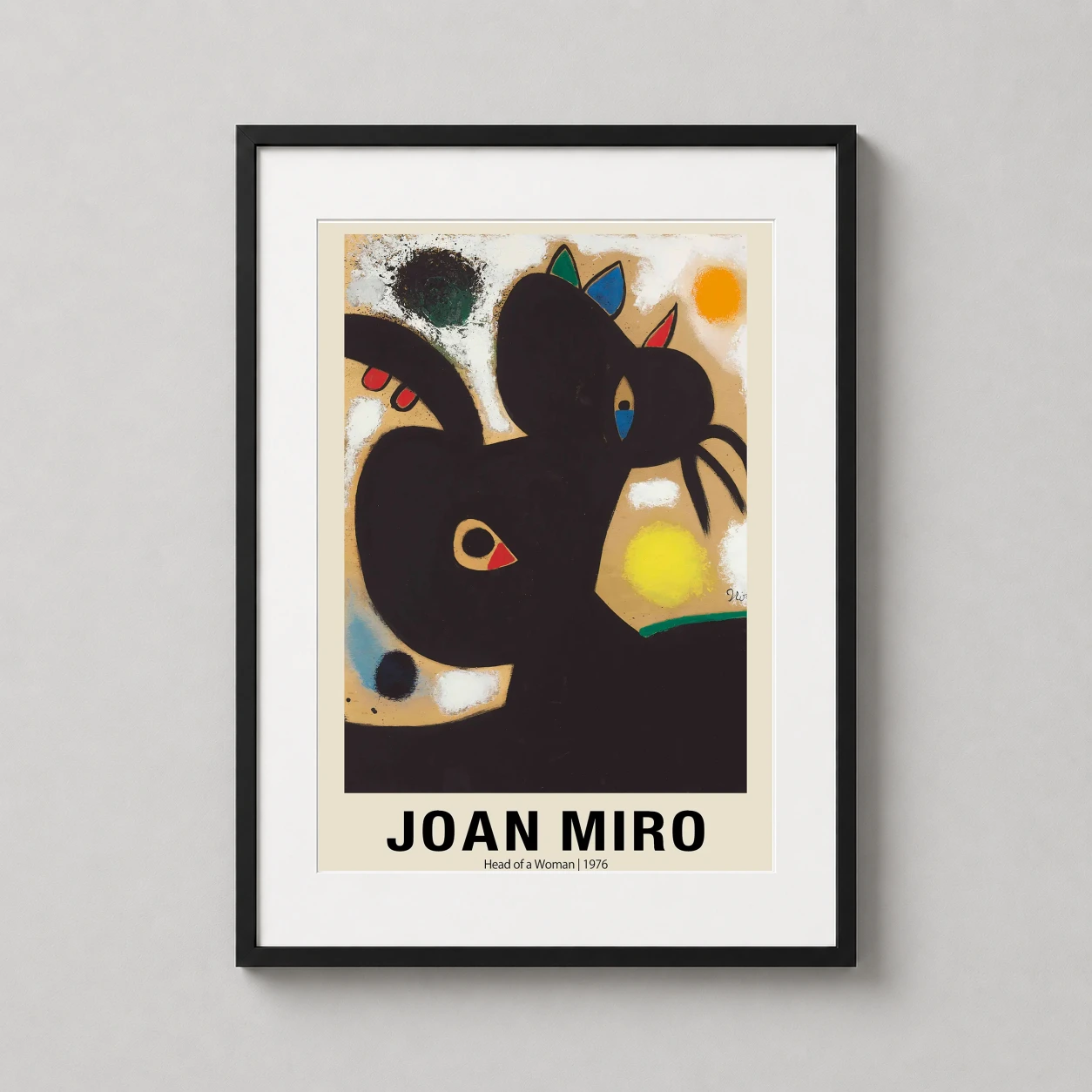 Room mockup of Joan Miro Head of a Woman 1976 Abstract Portrait Art Print, displayed as framed wall art in a living room setting as a portrait print with blue, yellow, and orange tones.