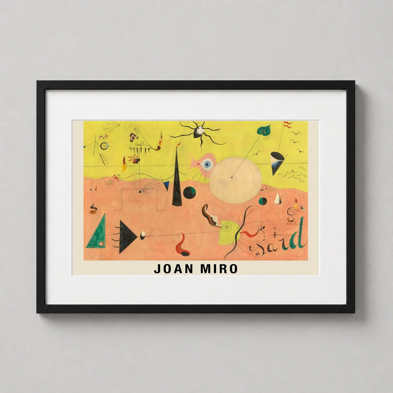 Room mockup of Joan Miro The Hunter Catalan Landscape Surrealist Art Print, displayed as framed wall art in a living room setting as a landscape print with yellow and pink tones.