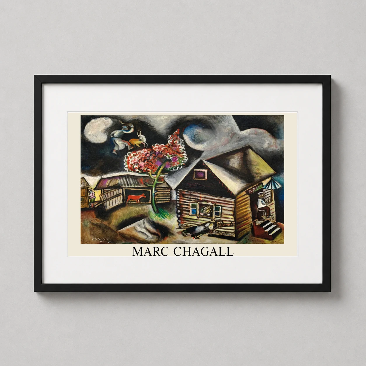Room mockup of Marc Chagall La Pluie Surrealist Village Scene Art Print, displayed as framed wall art in a living room setting as a landscape print with red tones.