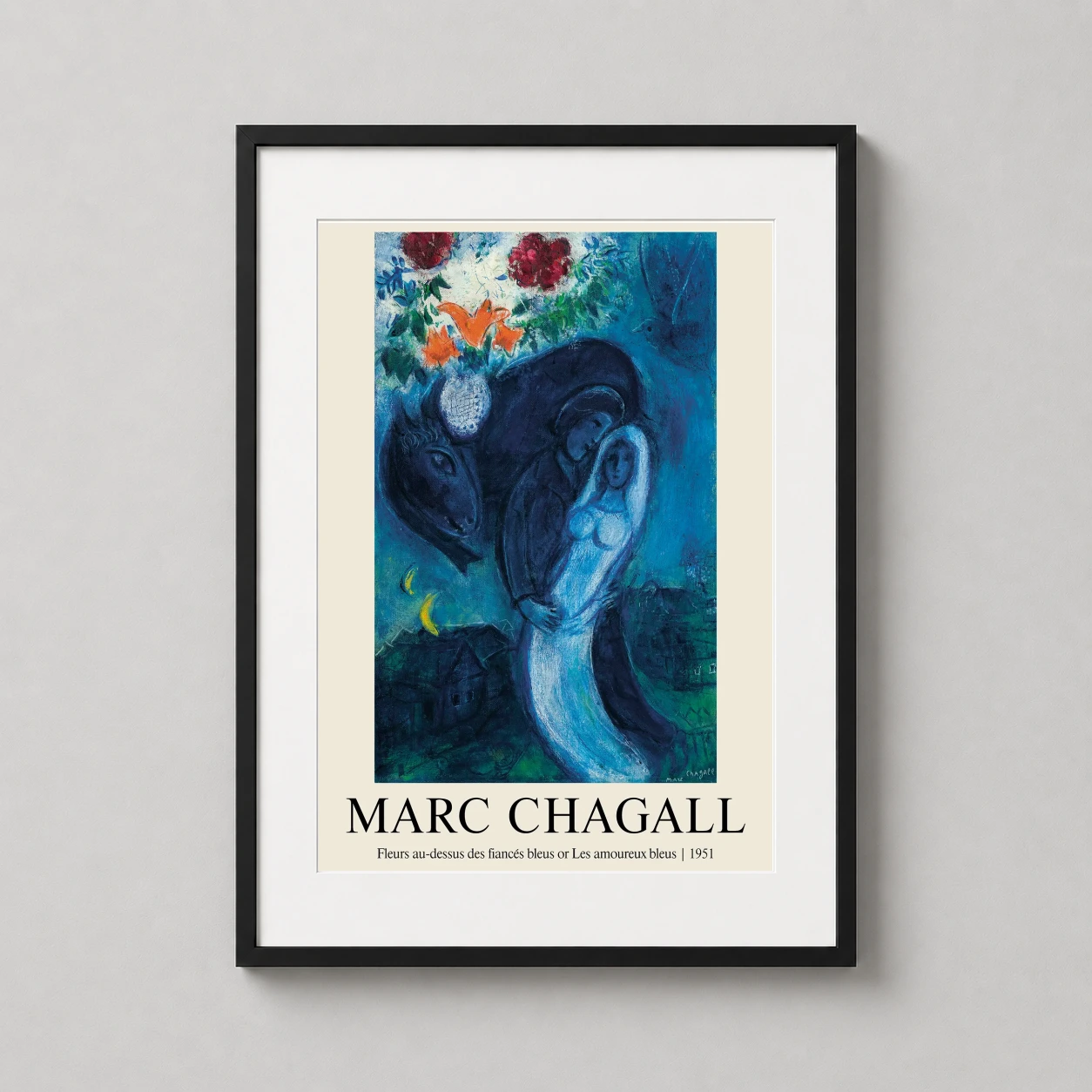 Room mockup of Marc Chagall Les Amoureux Bleus, The Blue Lovers 1951 Art Print, displayed as framed wall art in a living room setting as a portrait print with blue and teal tones.