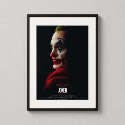 A framed print of the 2019 Joker movie poster hanging in a modern living room with neutral tones, highlighting the character's profile.