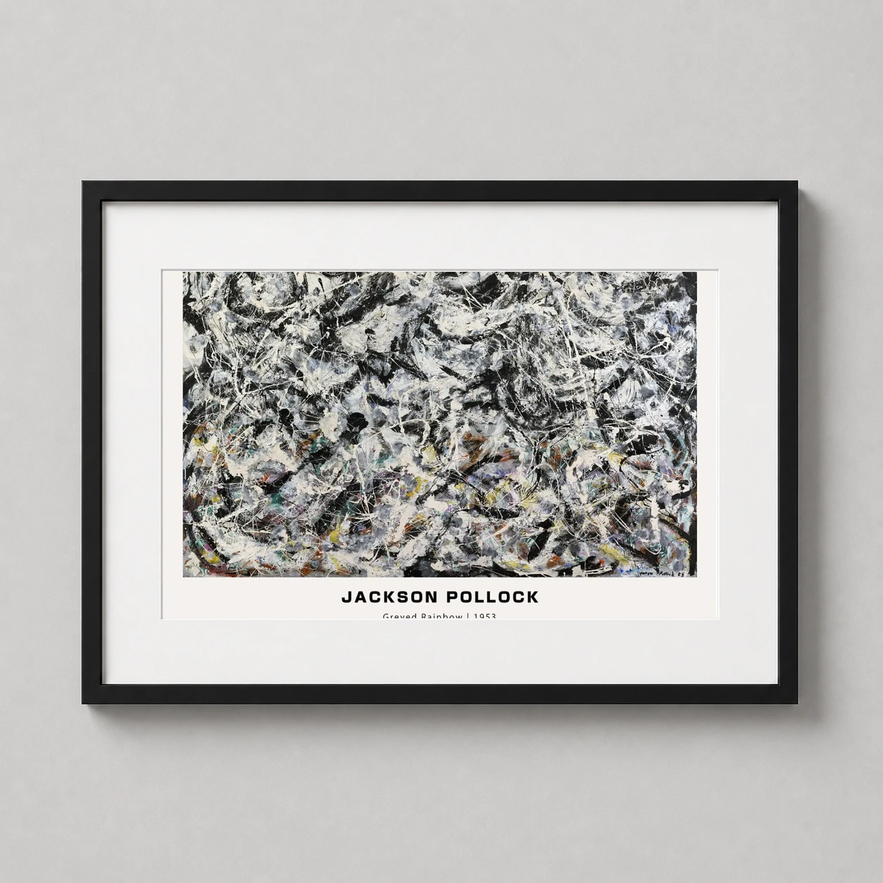 Room mockup of Jackson Pollock Greyed Rainbow 1953 Abstract Expressionist Art Print, displayed as framed wall art in a living room setting as a landscape print with black and white, blue, and yellow tones.
