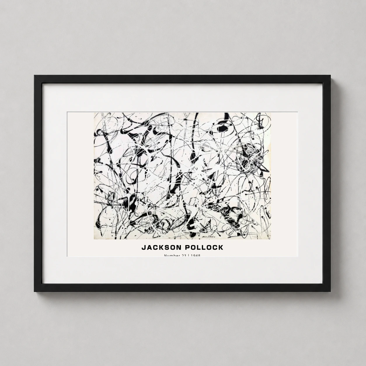 Room mockup of Jackson Pollock Number 23 1948 Abstract Expressionist Art Print, displayed as framed wall art in a living room setting as a landscape print with black and white tones.