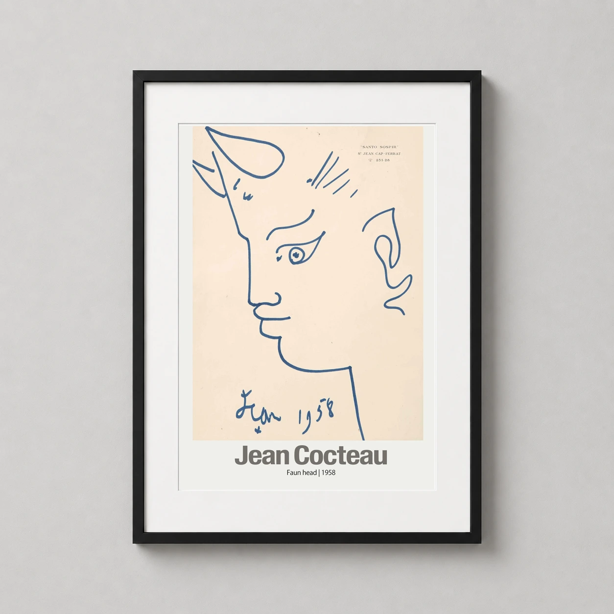 Room mockup of Jean Cocteau Faun Head, Santo Sospir 1958 Art Print, displayed as framed wall art in a living room setting as a portrait print with blue and cream tones.