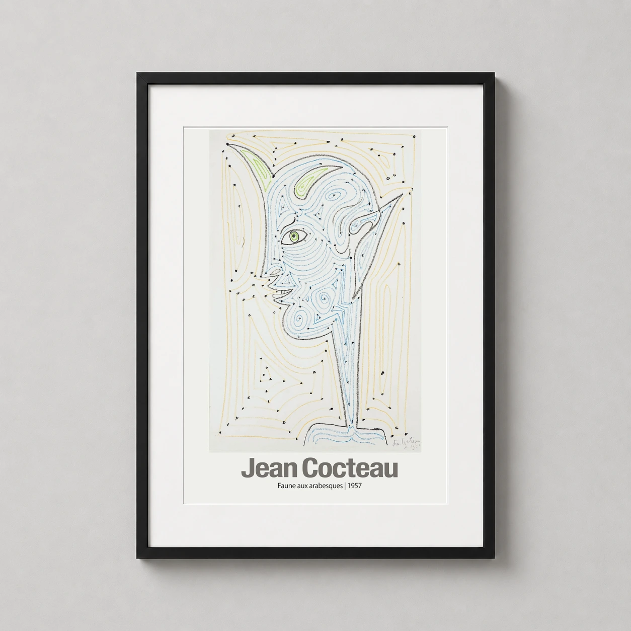 Room mockup of Jean Cocteau Faune aux Arabesques 1957 Surrealist Art Print, displayed as framed wall art in a living room setting as a portrait print with blue, green, and yellow tones.