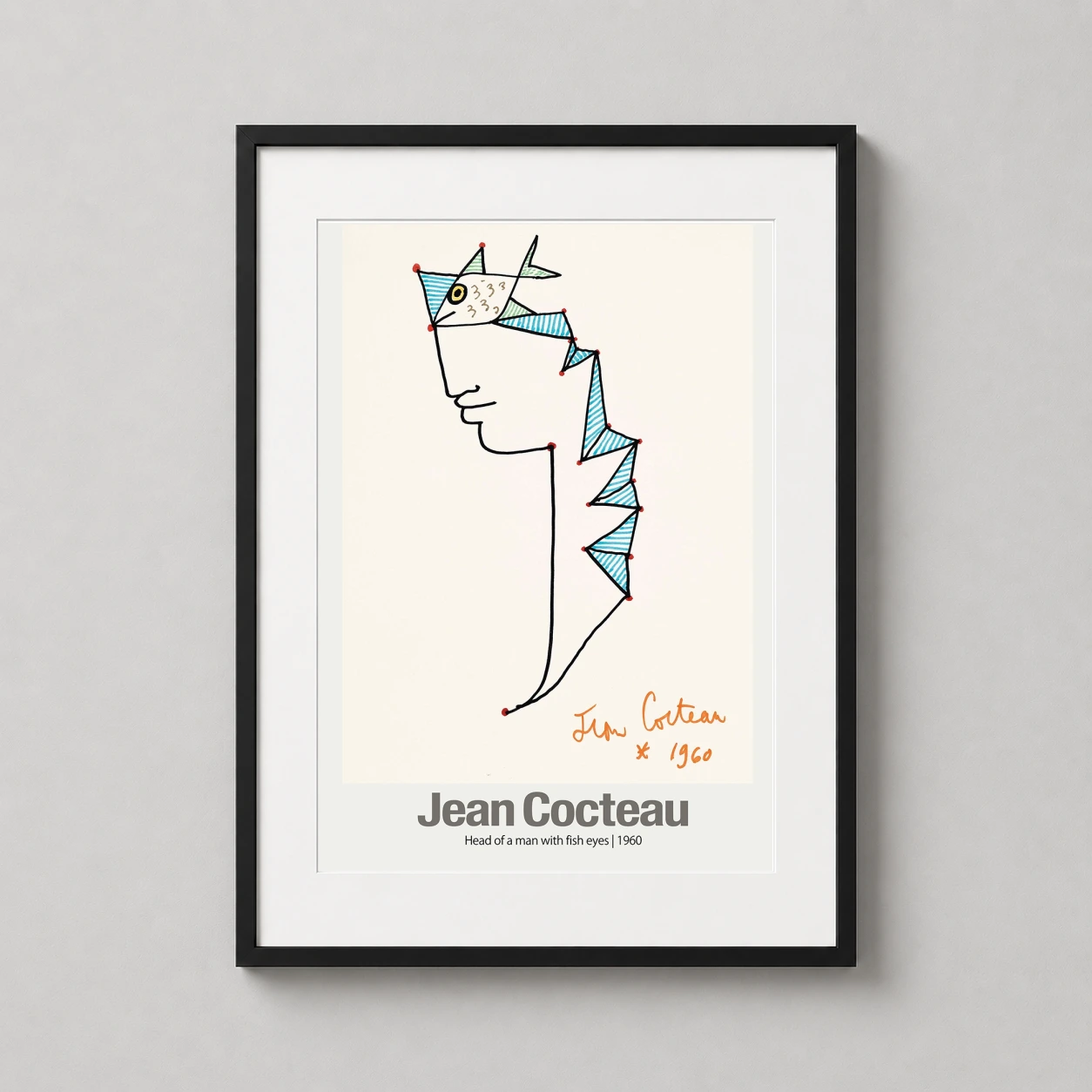 Room mockup of Head of a Man with Fish Eyes 1960, Jean Cocteau Art Print, displayed as framed wall art in a living room setting as a portrait print with blue, red, and cream tones.