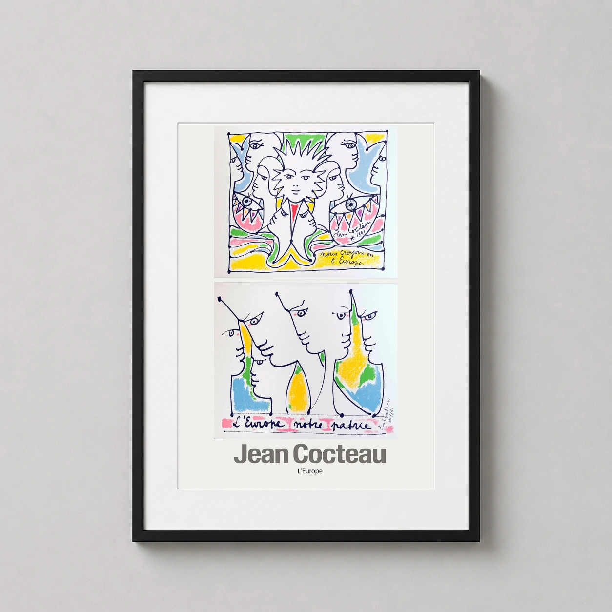 Room mockup of Jean Cocteau L'Europe 1961 French Surrealist Exhibition Art Print, displayed as framed wall art in a living room setting as a portrait print with blue tones.