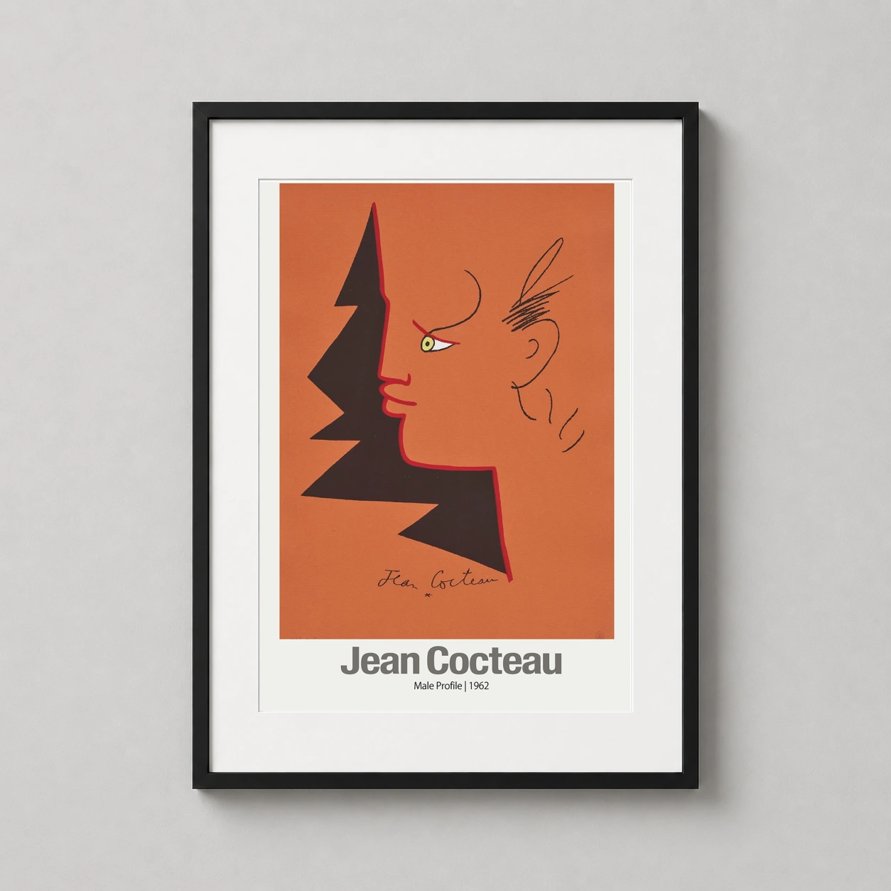 Room mockup of Jean Cocteau Male Profile 1962, Modernist Surrealist Art Print, displayed as framed wall art in a living room setting as a portrait print with yellow, orange, and red tones.