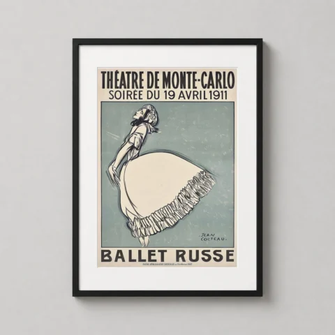 A framed Ballet Russe art print by Jean Cocteau displayed on a minimalist shelf in a sophisticated home office setting.