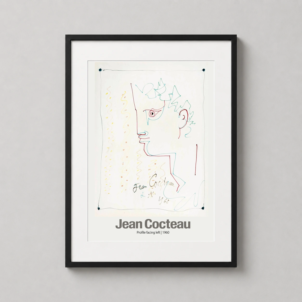 Room mockup of Jean Cocteau Profile Facing Left 1960 Sketch Art Print, displayed as framed wall art in a living room setting as a portrait print with blue, yellow, and red tones.