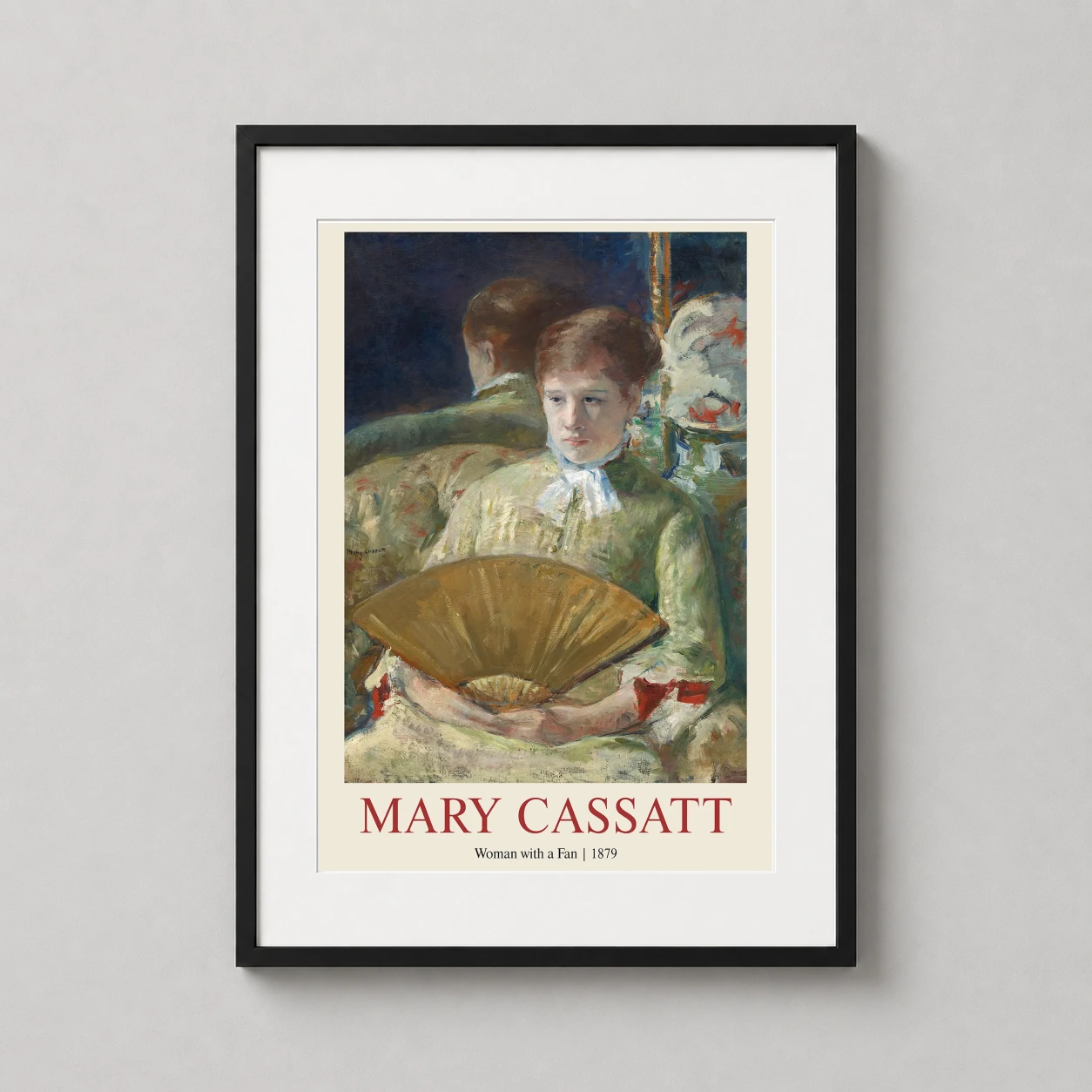 Room mockup of Mary Cassatt Woman with a Fan 1879 Impressionist Art Print, displayed as framed wall art in a living room setting as a portrait print with green, gold, and red tones.
