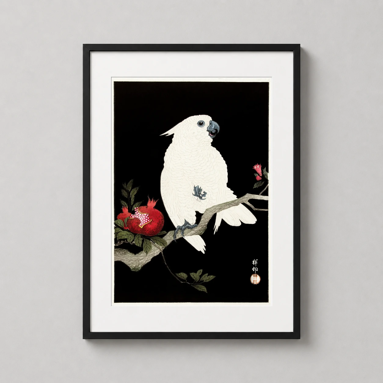 Room mockup of Cockatoo and Pomegranate Japanese Woodblock Style Art Print, displayed as framed wall art in a bedroom setting as a portrait print with green, red, and black tones.