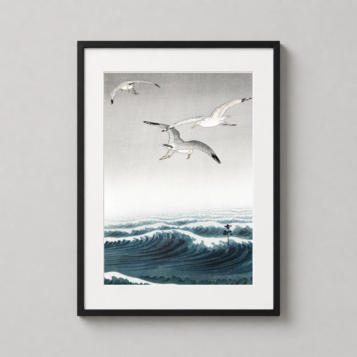 Room mockup of Seagulls Over Waves Japanese Woodblock Art Print by Ohara Koson, displayed as framed wall art in a bedroom setting as a portrait print with blue, grey, and white tones.