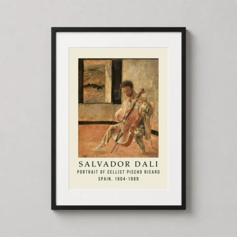 A framed Salvador Dali Pischo Ricard art print hanging in a well-lit home office above a wooden desk.