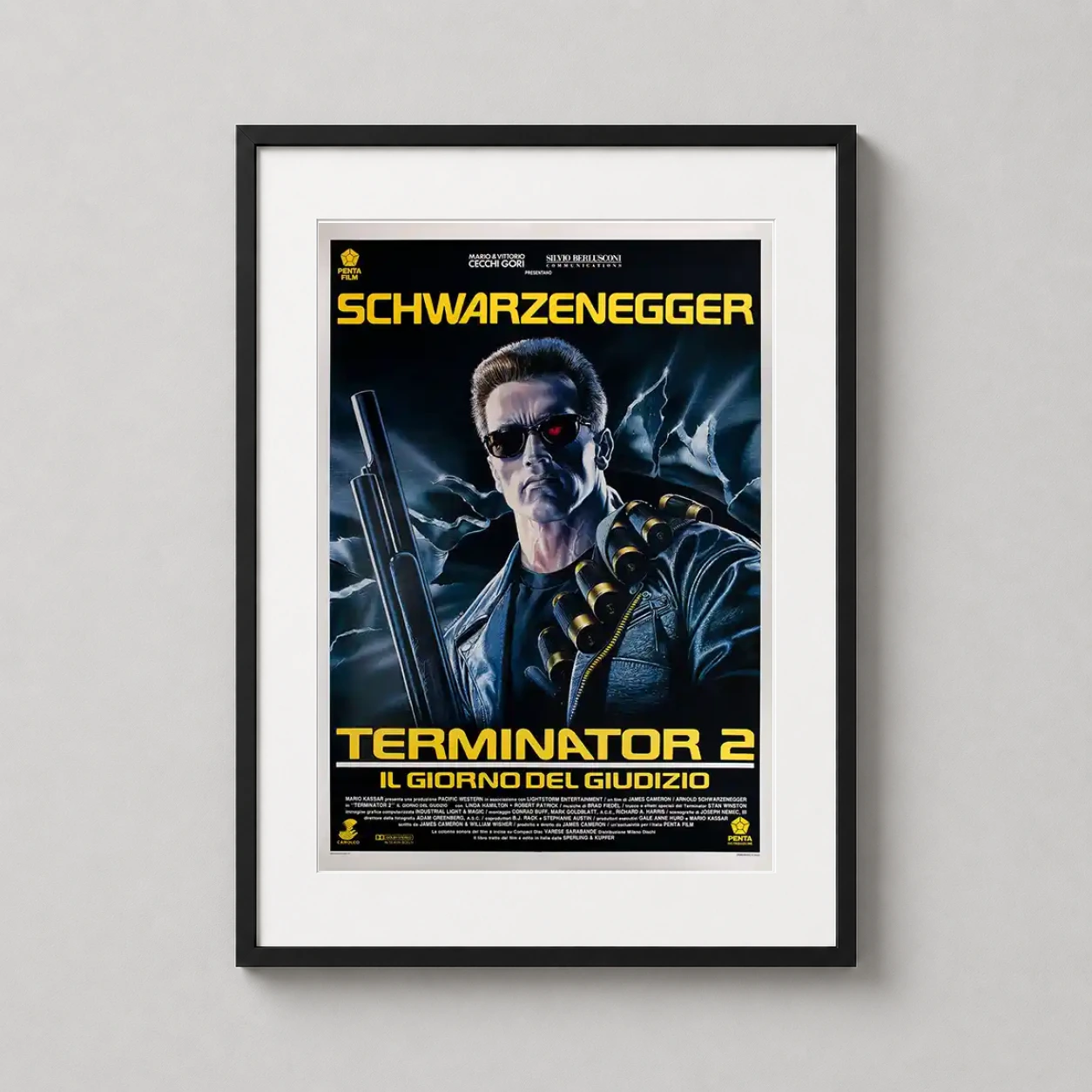 Room mockup of Terminator 2: Judgment Day Italian Movie Art, Arnold Schwarzenegger Poster, displayed as framed wall art in a home theater setting as a portrait print with blue and red tones.
